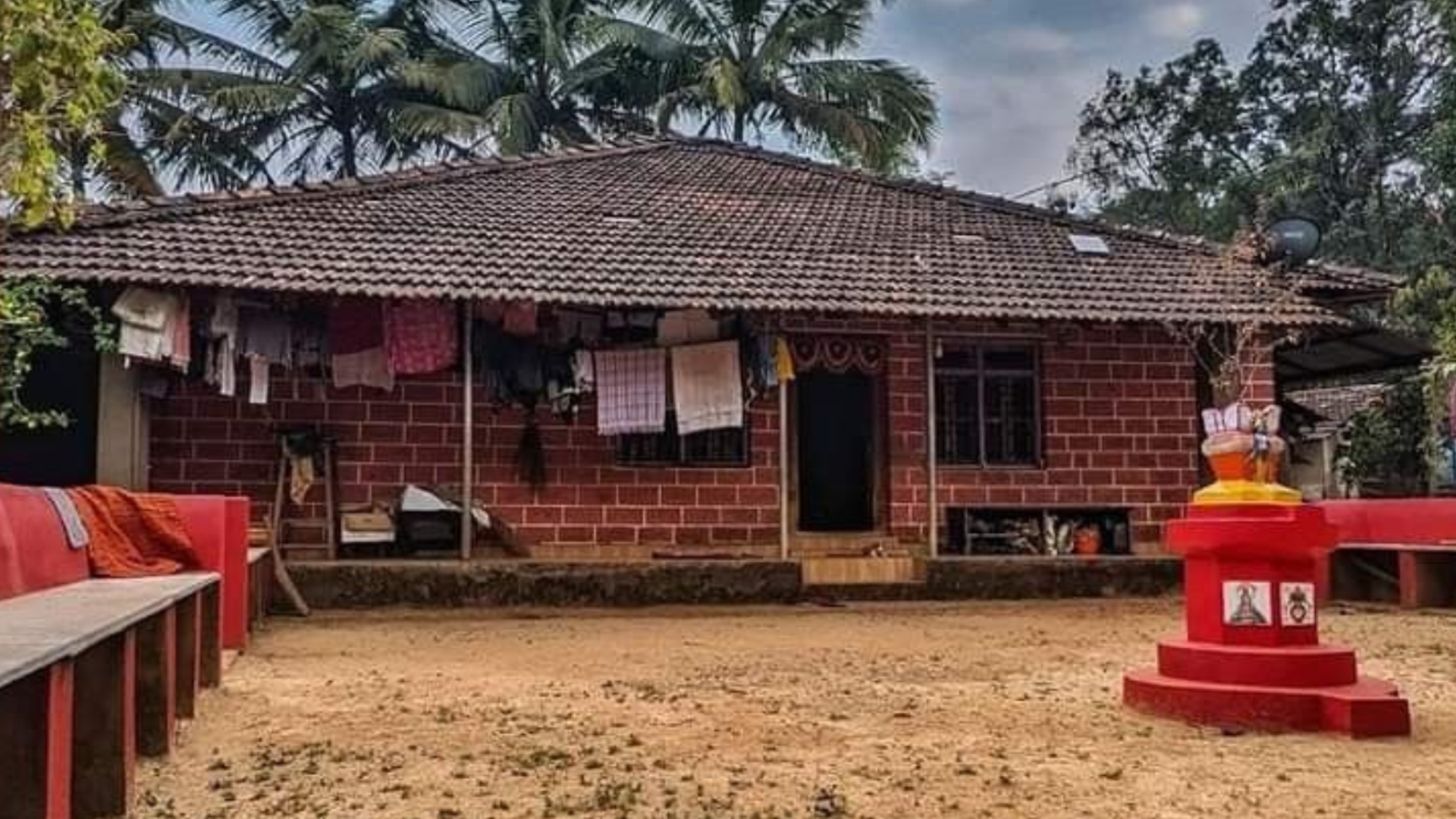 Heritage house with a shaded verandah in a Kokan village