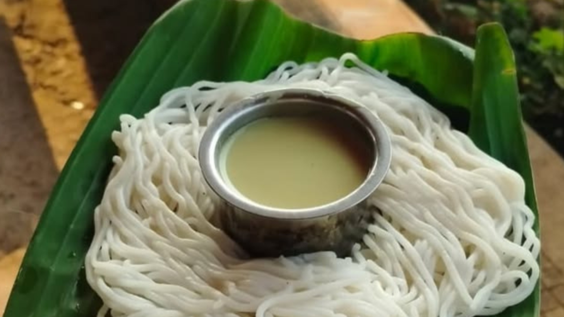 Hand-pressed shevai on a banana leaf with sweet coconut milk