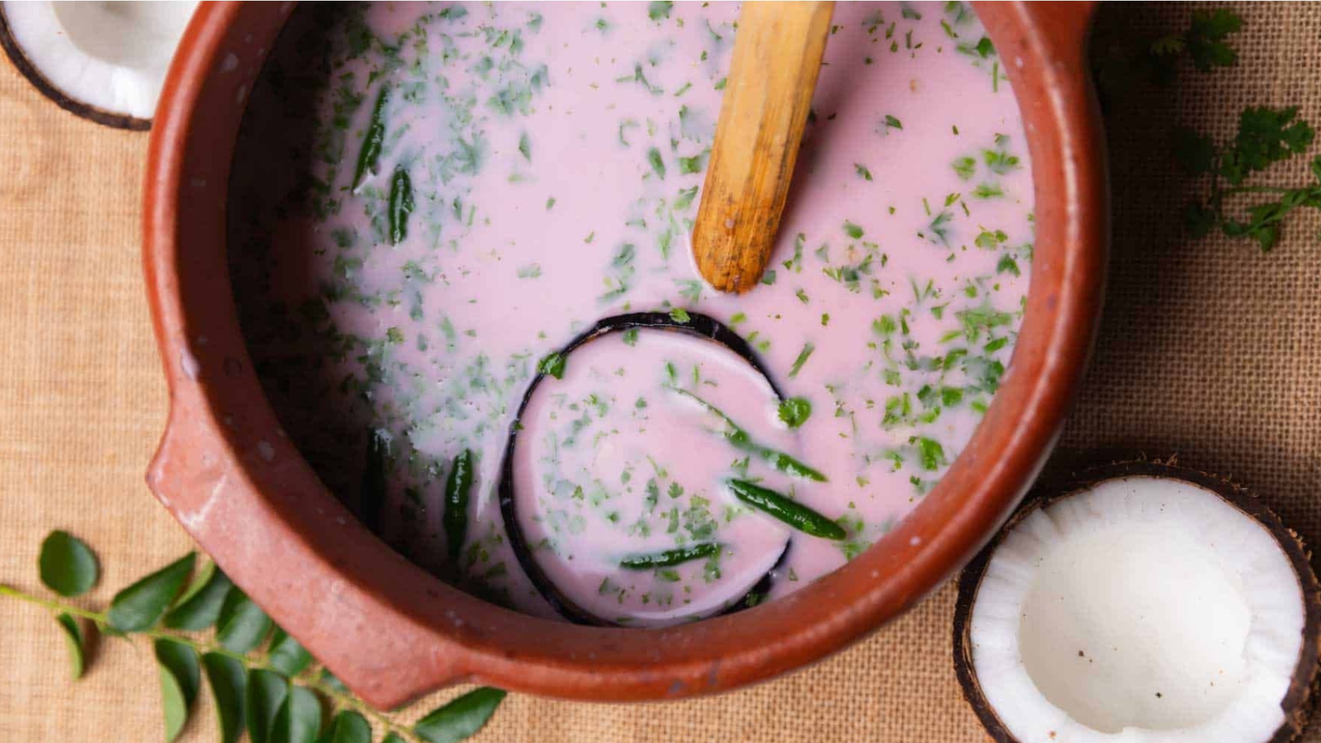 Pink solkadhi served in a traditional clay bowl