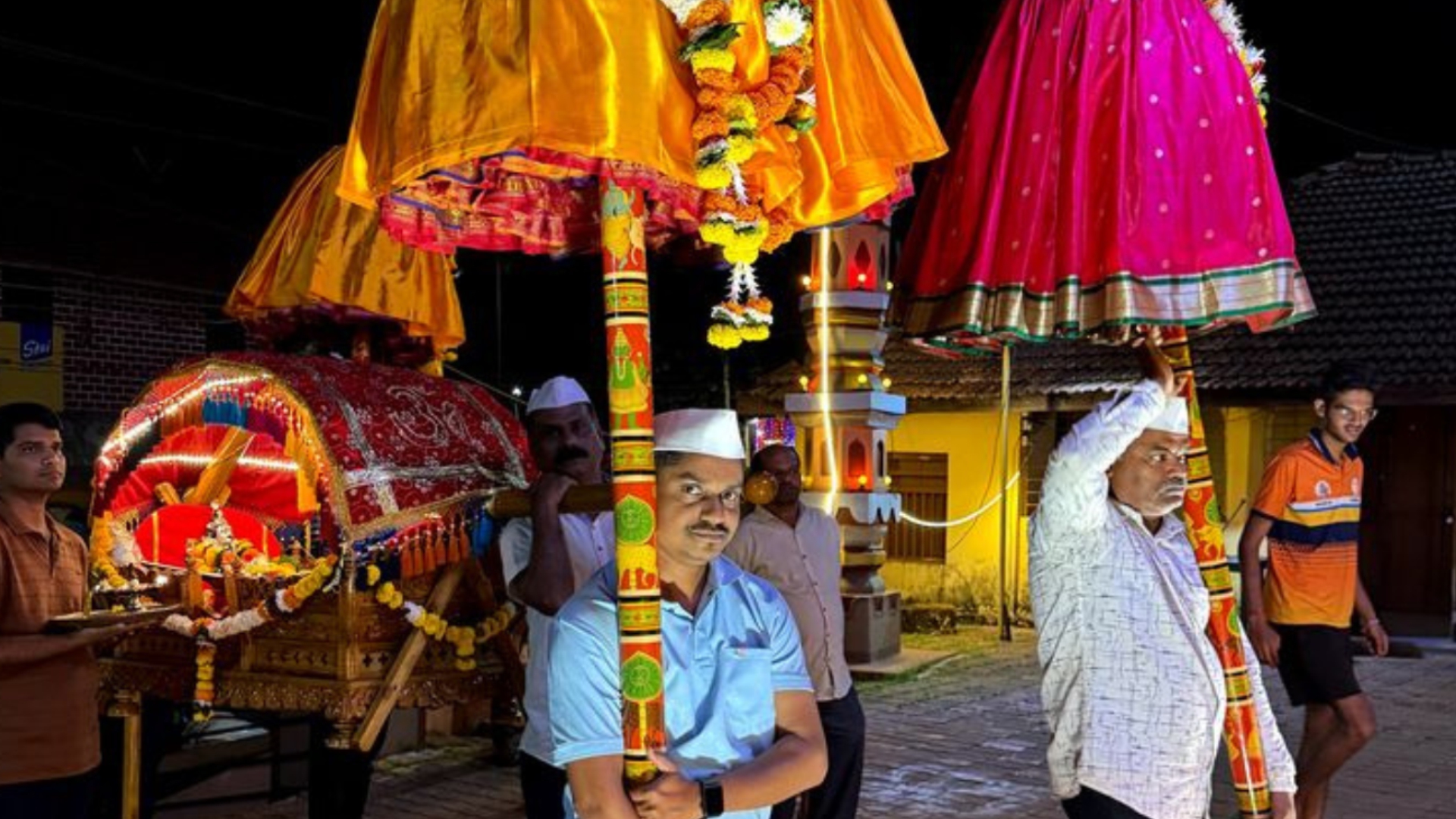 Colourful decorated palkhi carried through village streets