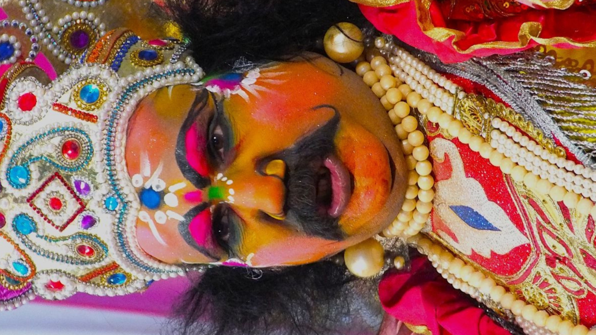 Ornate hand-painted festival mask used in coastal folk theatre