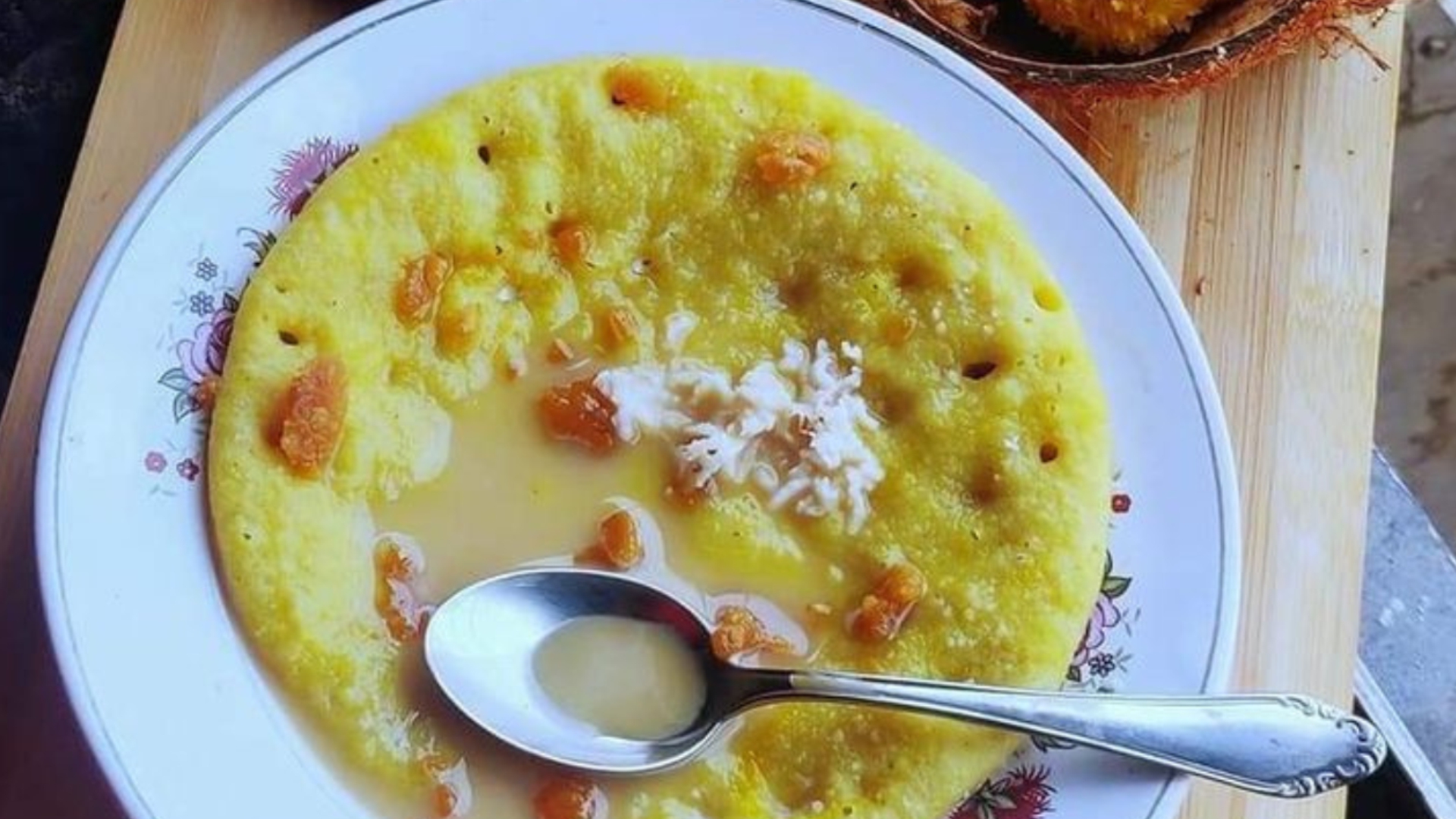 Bowl of warm festive kheer topped with coconut and cashew