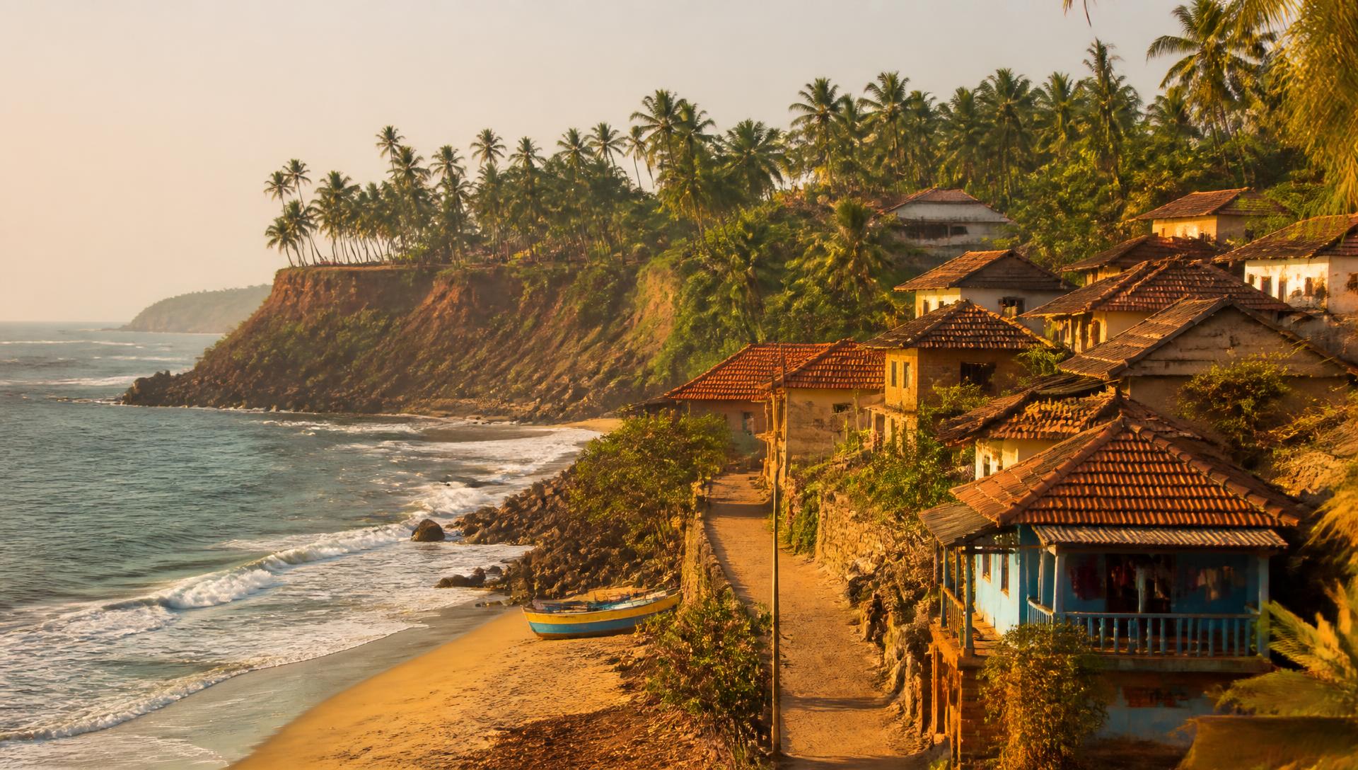 Kokan coastal village with laterite cliffs and tiled-roof houses at golden hour